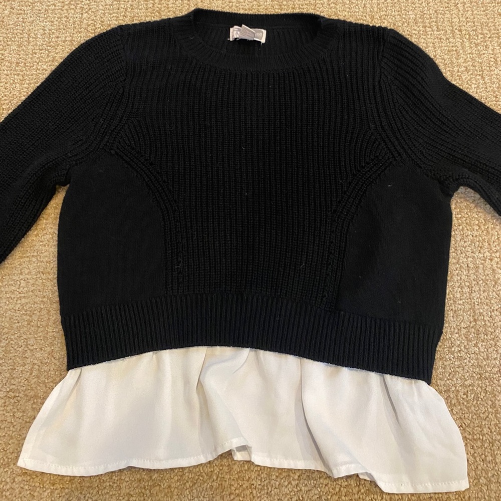 Black sweater with white blouse detailing